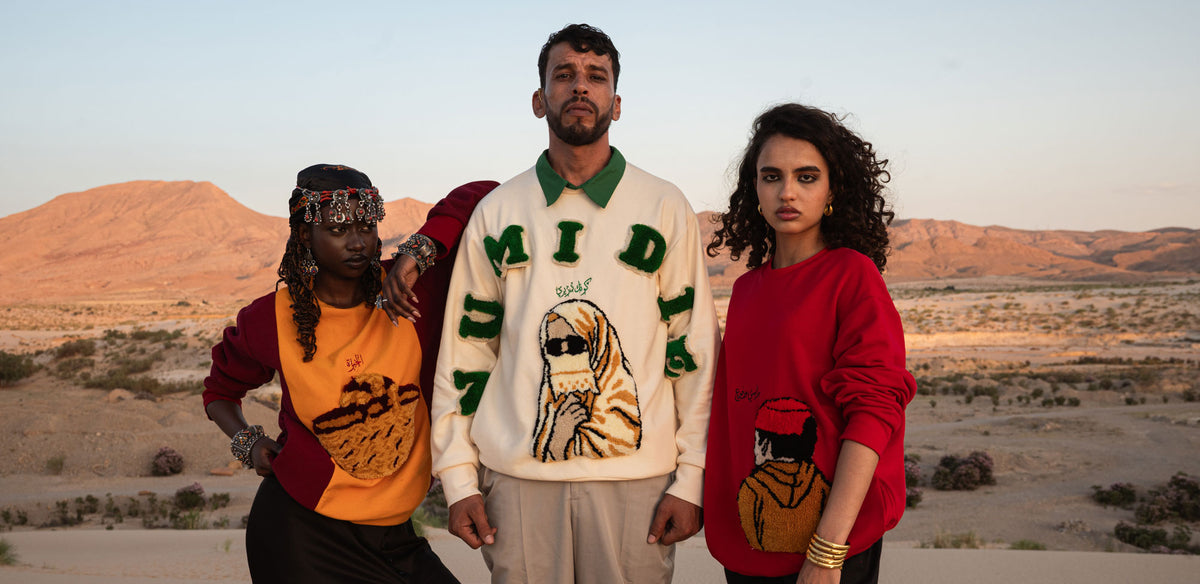 Campagne Numidie Automne-Hiver 2026 présentant trois mannequins portant les pulls Kouffa jaune, Tarboucha rouge et Numidie écru, dans un paysage algérien.